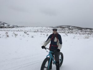 Photo of Dr. Young biking in the snow in Northern Utah