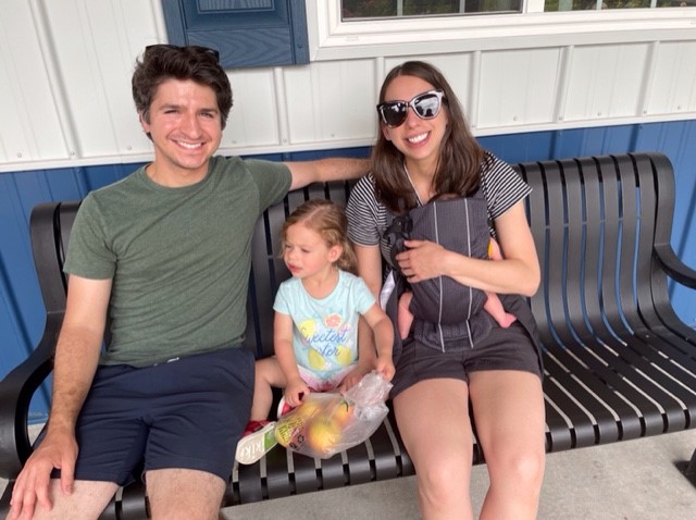 Joshua Dowd and family sitting on a bench.