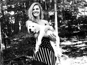 Black and White photo of Katie holding her dog