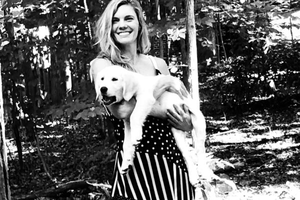 Black and White photo of Katie holding her dog