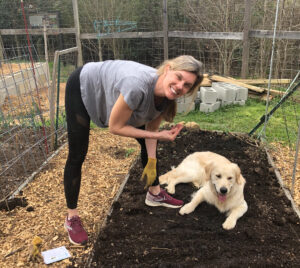 Photo of Katie and her dog in the garden