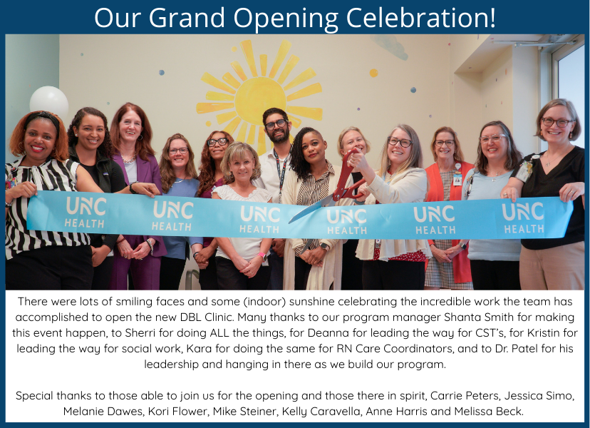Group of UNC Health staff smiling and holding a ribbon at the grand opening of the new DBL Clinic, with a sun mural in the background.