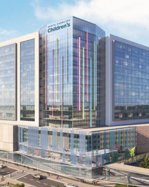 Modern glass hospital tower labeled “NC Children’s,” with colorful vertical accents, shown in a planned development rendering.