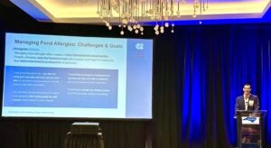 Dr. Hunter Smith presents “Managing Food Allergies: Challenges & Goals” slide.