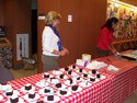 Patty Holloway and Arlene Sandoval at the cake table.