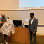 Dr. Henrik Dohlman displays Dr. Lucas Aponte-Collazo's Pharmacology White Coat at his White Coat Ceremony