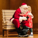 Santa and child at Annual Awards Holiday Party 2022