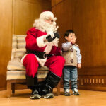 Santa and child at Annual Awards Holiday Party 2022