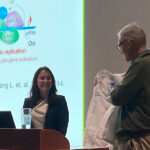 Danielle Chappel, PhD, receives her Pharmcology White Coat from Henrik Dohlman at her PhD defense.