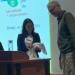 Danielle Chappel, PhD, receives her Pharmcology White Coat from Henrik Dohlman at her PhD defense.