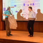 Dr. Henrik Dohlman presents Dr. Peyton Sandroni with his White Coat after defending his PhD thesis.