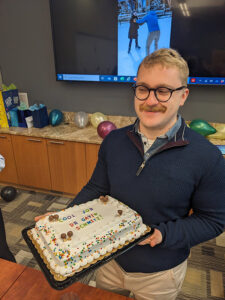Gavin Schmitz, PhD holds his celebration cheesecake!