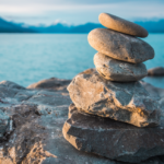 stones stacked by body of water
