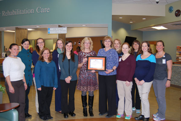 CRC therapists take a group photo with Kaye Gooch at the award presentation. See the story for more details and the names of each therapist.