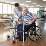 therapist with patient in wheelchair