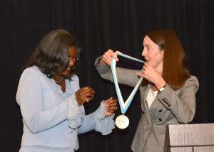 Melina Kibbe, MD, presenting Dr. Andrea Hayes-Jordan with her medallion.