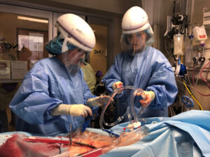 Dr. Raff performing ECMO on a COVID-19 patient