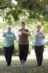 Group exercising by practicing Tai Chi 