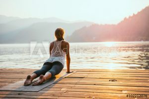woman doing yoga at sunrise