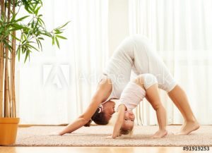 mother and little girl practicing yoga